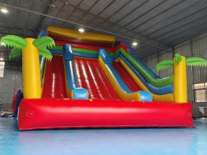 China New Design Tarpaulin Fireproof Commercial Inflatable High Slide Palm Theme Giant Inflatable Slide Castle For Kids And Ad wholesale