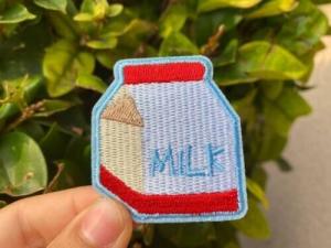 China Milk Custom Embroidered Patch Badge Sew On / Iron On Blue Merrow Border wholesale